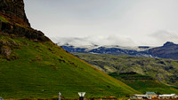 Black basalt mountains, created by volcanic activity covered by glaciers